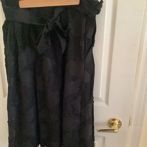 Black a-line skirt with black appliqué and tie front Karl lagerfield. Large